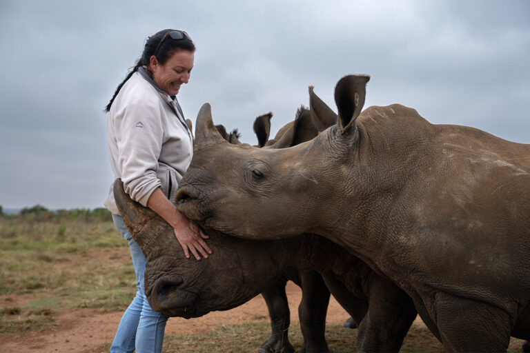 Orphanage manager Claudia Andrione with older rhino orphans at the orphanage.