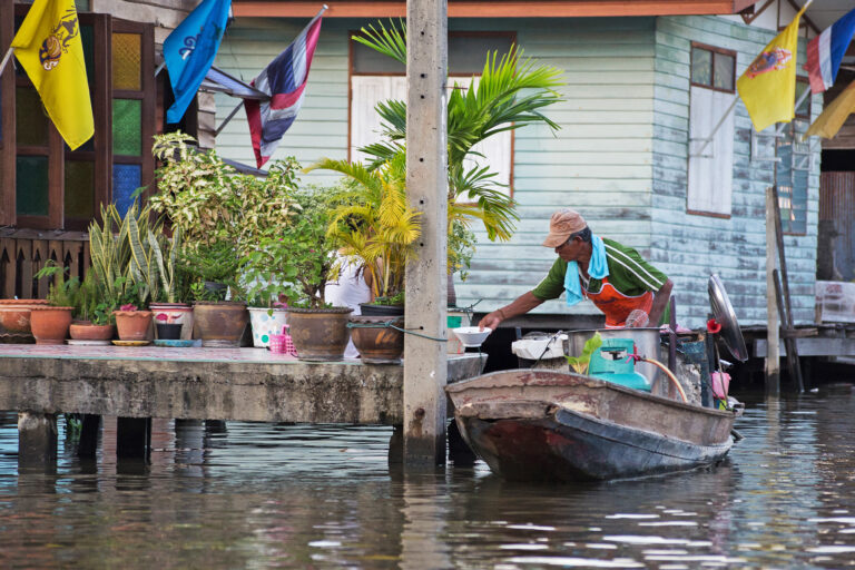 A boat merchant in the canals of Bangkok, Thailand.
