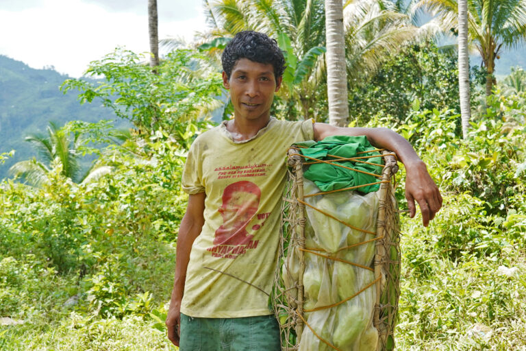 Posito Daom, a Pala'wan, pauses on his descent to the lowlands to sell chayote cultivated using the no-till method, a sustainable practice that avoids turning over and disturbing the soil, according to studies.