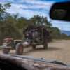 A man drives a koy-yun loaded with logs through Choam village in Kampong Speu province, Cambodia. Credit: Andy Ball/Mongabay.