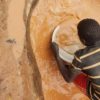 Saliou Hassana, a 17-year-old gold miner, extracting and collecting gold nuggets using mercury at Kambélé III. Image © Yannick Kenné.